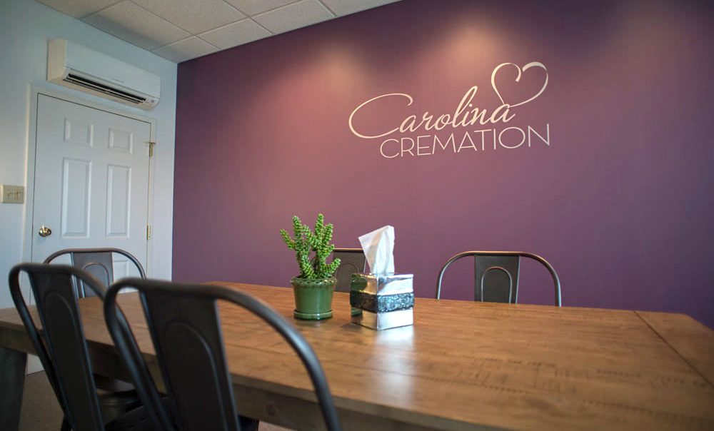Arrangement table with Carolina Cremation logo wall vinyl